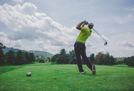 person hitting a golf ball