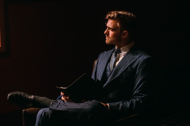 person in suit sitting