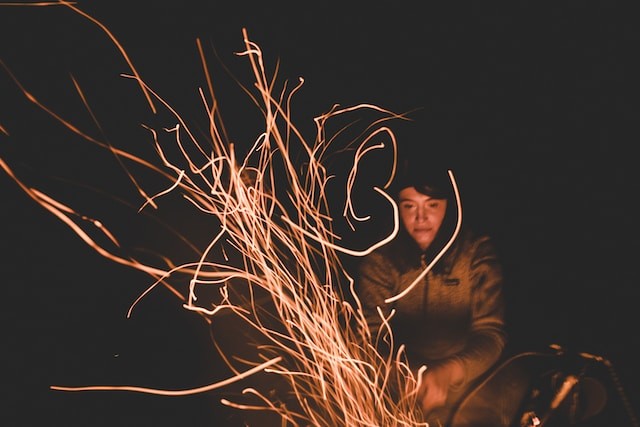 person sitting near the bonfire