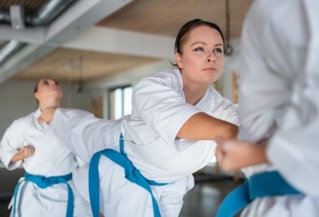 person training bjj having blue belt