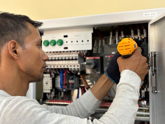 a-man-is-working-on-an-electrical-panel