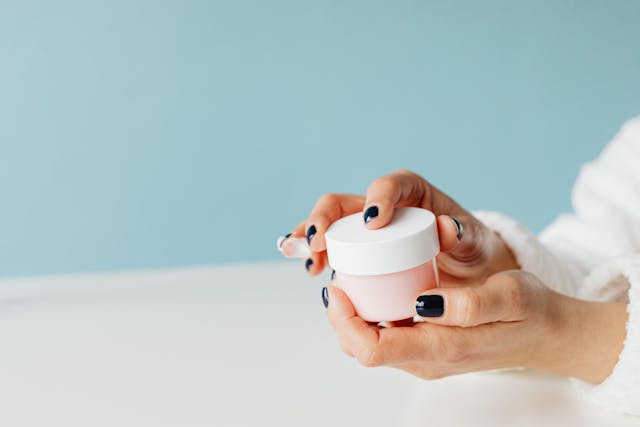 close-up-of-woman-holding-a-container-with-cream